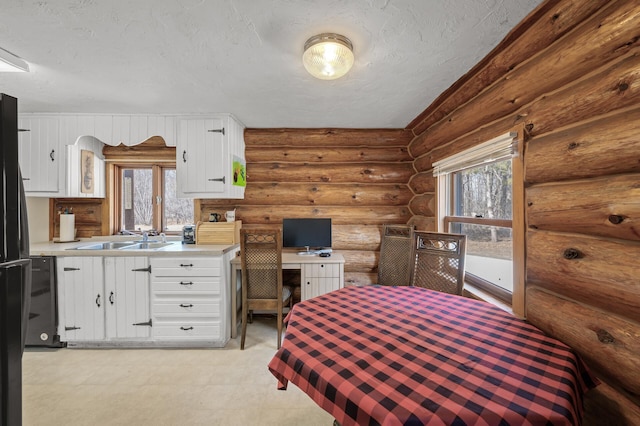 bedroom featuring a textured ceiling, light floors, and a sink