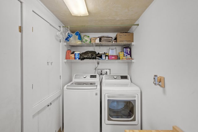 laundry area featuring separate washer and dryer and laundry area