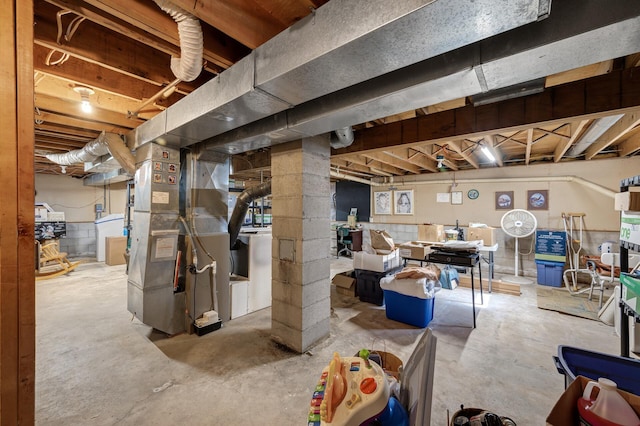 unfinished basement featuring heating unit