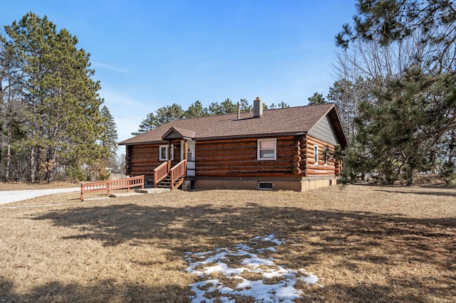 log home with a chimney, log exterior, a shingled roof, and entry steps