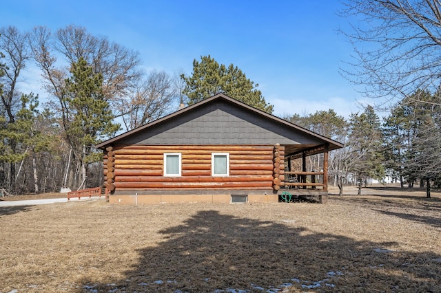 view of property exterior with log exterior