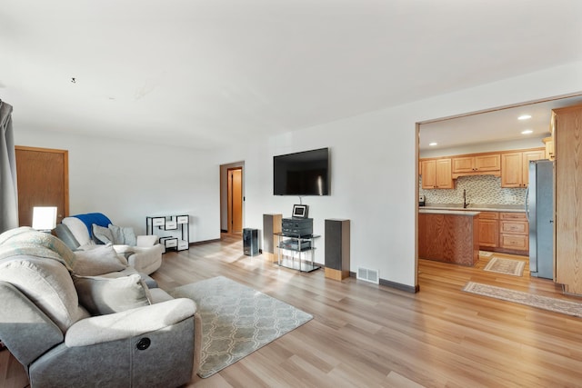 living room featuring visible vents, recessed lighting, light wood-type flooring, and baseboards