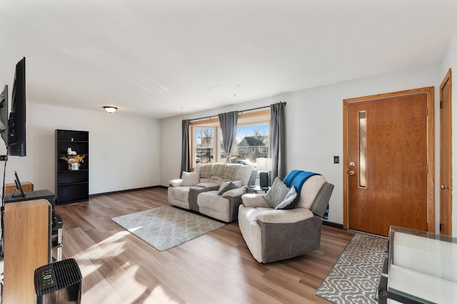 living room with baseboards and wood finished floors