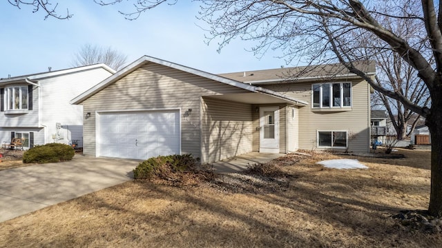 split level home with a garage and driveway