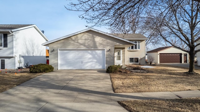 view of front of home with a garage, an outbuilding, and concrete driveway