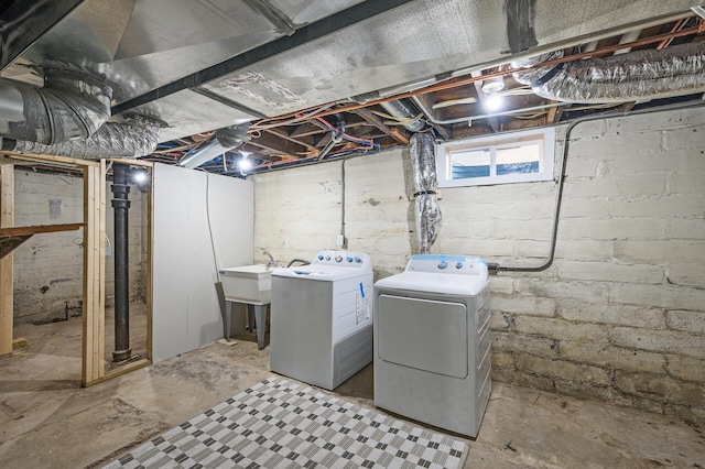 laundry area with a sink, separate washer and dryer, and laundry area