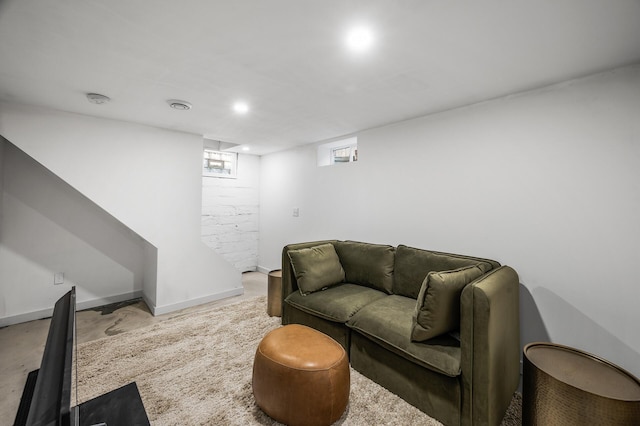 living room with baseboards and concrete flooring