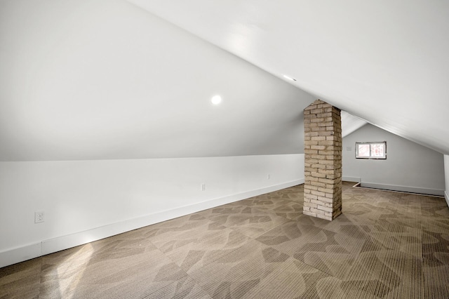 bonus room featuring decorative columns, baseboards, carpet, and vaulted ceiling