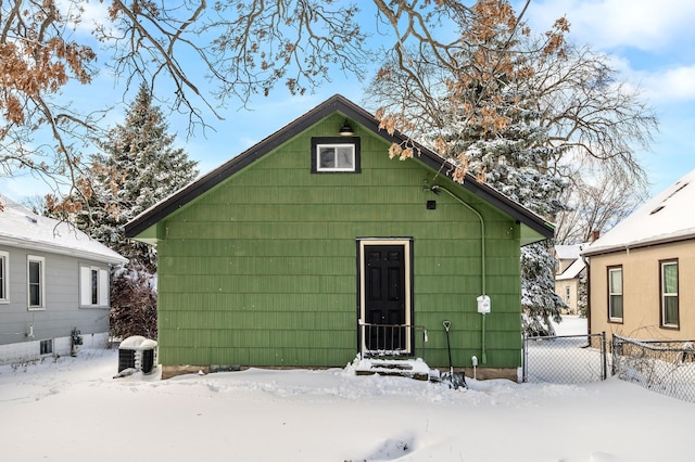 snow covered property with fence