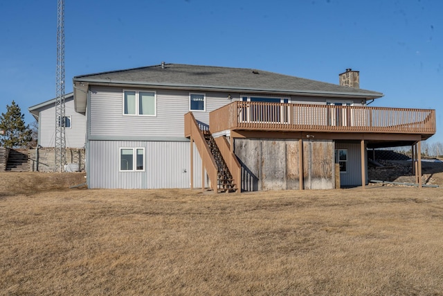 back of house featuring a yard, a chimney, a deck, and stairs