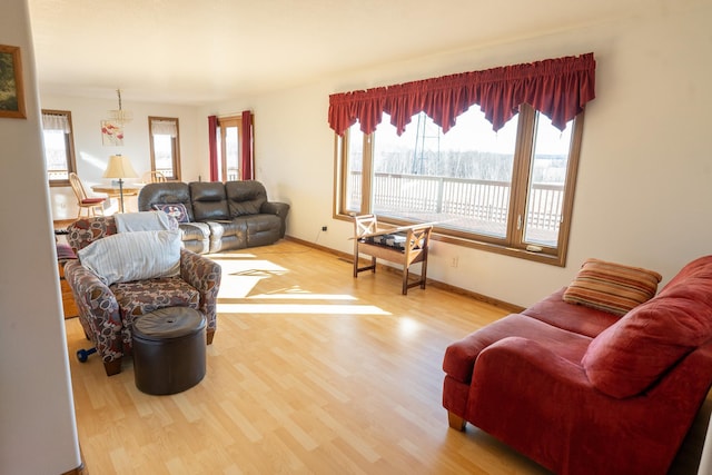 living area featuring baseboards and wood finished floors