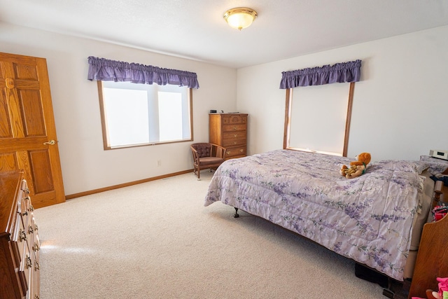 bedroom with carpet and baseboards