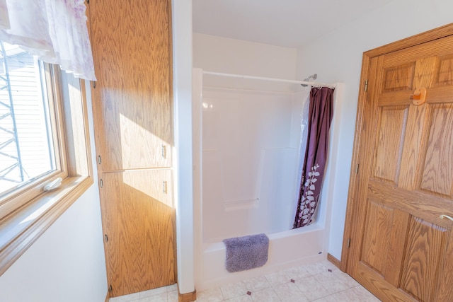 full bath featuring shower / bath combination with curtain and tile patterned floors