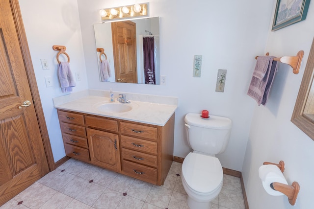 full bathroom with vanity, toilet, baseboards, and tile patterned flooring