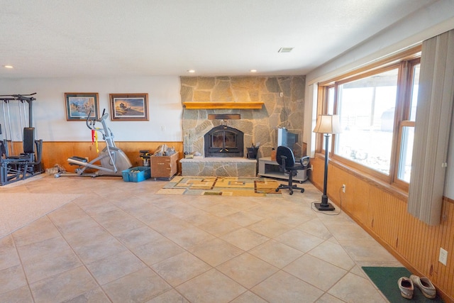 living room with a wainscoted wall, visible vents, recessed lighting, wooden walls, and light tile patterned flooring