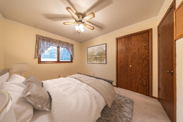 bedroom with light carpet, a textured ceiling, ceiling fan, and crown molding