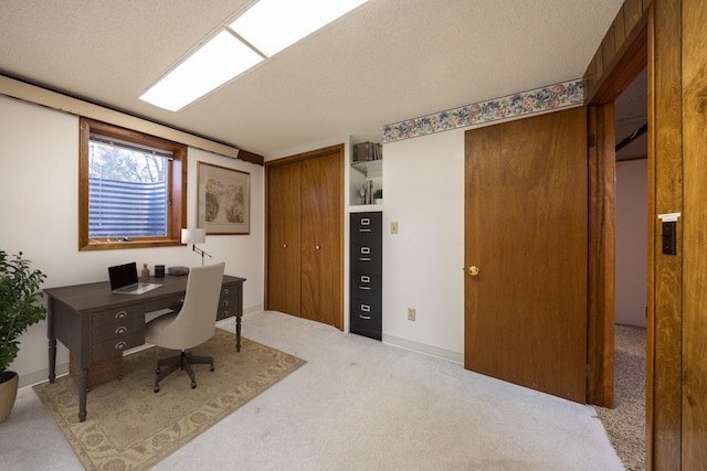 office space featuring a textured ceiling and carpet