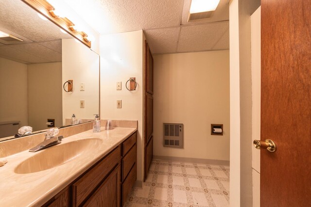 bathroom with tile patterned floors, visible vents, a paneled ceiling, and vanity