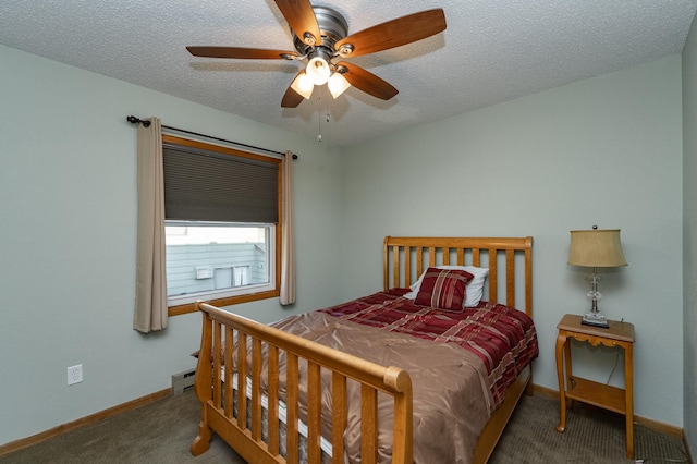 carpeted bedroom with ceiling fan, a textured ceiling, and baseboards