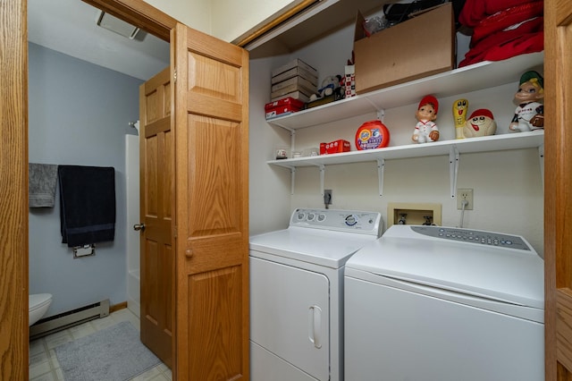 clothes washing area featuring laundry area, independent washer and dryer, and a baseboard heating unit