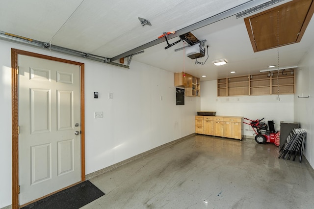 garage with electric panel, baseboards, and a garage door opener