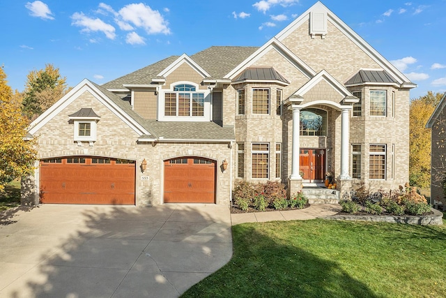 view of front of property featuring concrete driveway, a garage, brick siding, and a front lawn