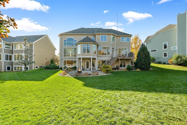 back of house with a deck, a patio area, stairway, and a lawn