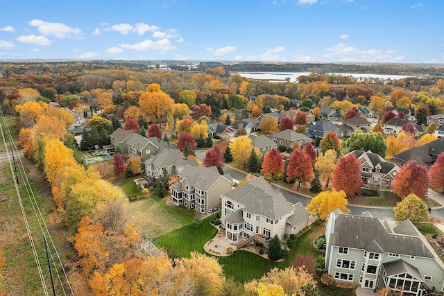 drone / aerial view featuring a water view and a residential view