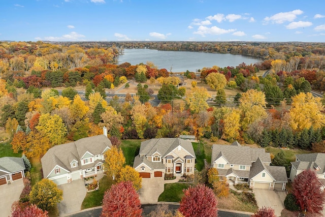 birds eye view of property with a residential view, a forest view, and a water view