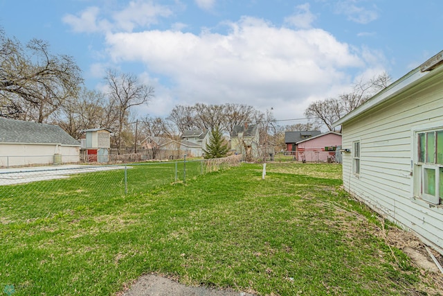 view of yard featuring fence and a residential view