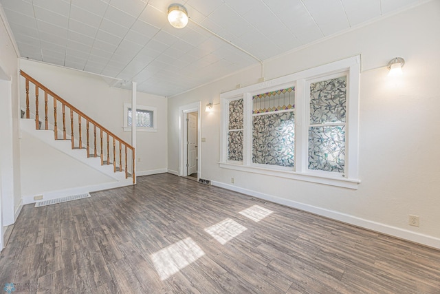 1524 1st Ave S, Fargo, ND 58103 - unfurnished living room with wood finished floors, stairs, baseboards, and crown molding