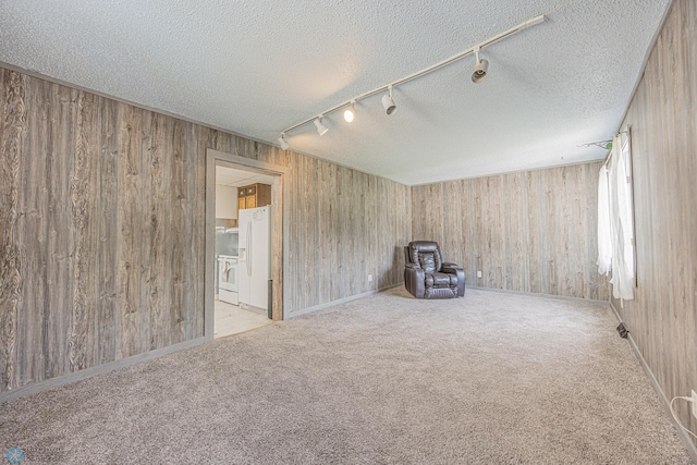 1524 1st Ave S, Fargo, ND 58103 - spare room with track lighting, wood walls, carpet floors, and a textured ceiling