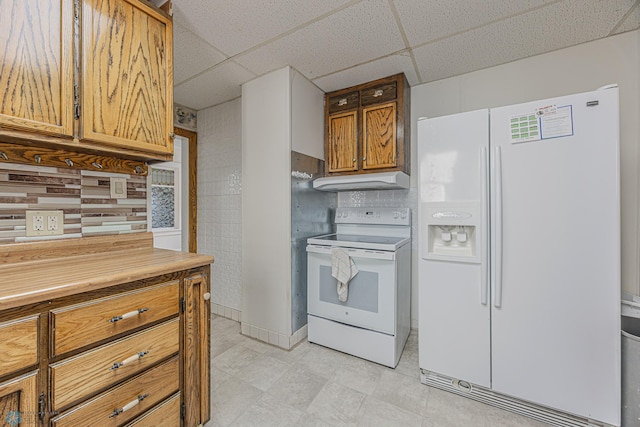 1524 1st Ave S, Fargo, ND 58103 - kitchen featuring white appliances, a drop ceiling, exhaust hood, brown cabinets, and backsplash