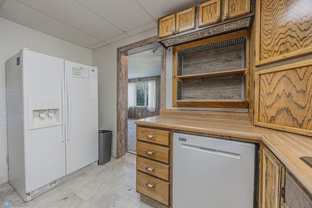 1524 1st Ave S, Fargo, ND 58103 - kitchen with white appliances, brown cabinetry, a drop ceiling, light flooring, and butcher block countertops