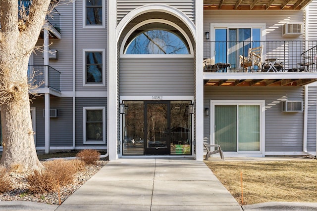 view of exterior entry featuring a wall mounted AC