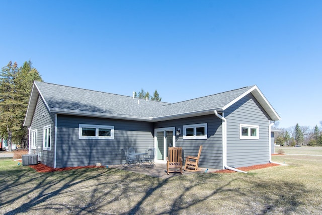 1001 Call Pl, Little Falls, MN 56345 - back of house featuring a patio area, roof with shingles, a yard, and central AC
