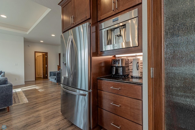 kitchen with dark wood-style flooring, recessed lighting, open floor plan, and stainless steel fridge with ice dispenser