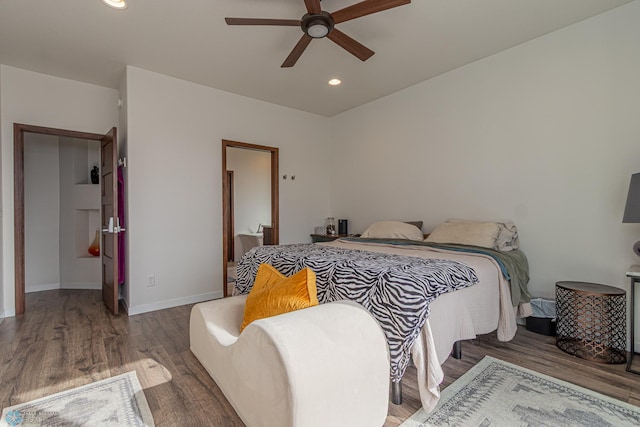 bedroom featuring recessed lighting, baseboards, wood finished floors, and a ceiling fan