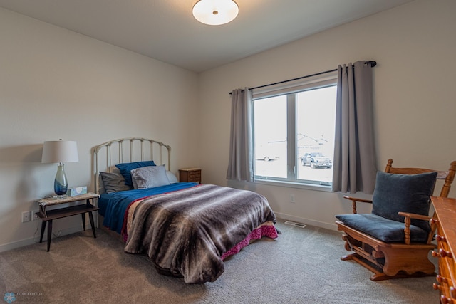 carpeted bedroom with visible vents and baseboards