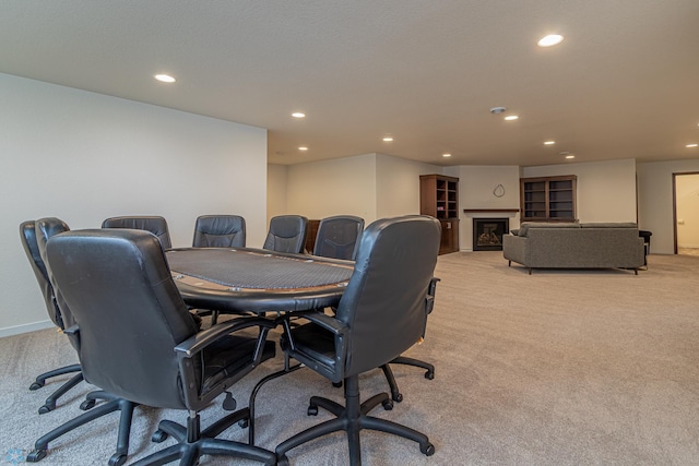 office area featuring light carpet, recessed lighting, a fireplace, and baseboards