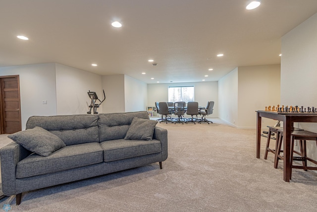 living area featuring recessed lighting, baseboards, and light colored carpet