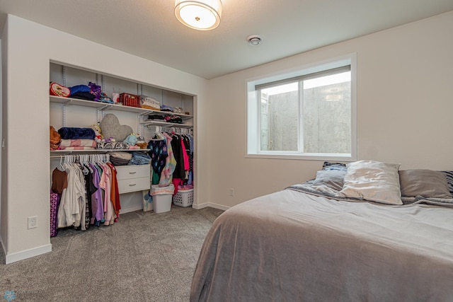 bedroom featuring a closet, carpet floors, and baseboards