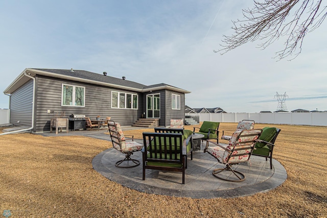 rear view of house with a lawn, entry steps, a patio, and fence