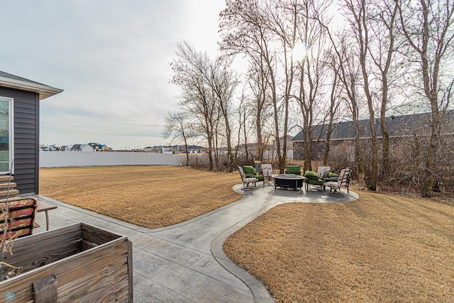 view of yard with a fenced backyard, an outdoor fire pit, and a patio