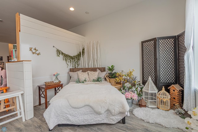 bedroom featuring recessed lighting and wood finished floors