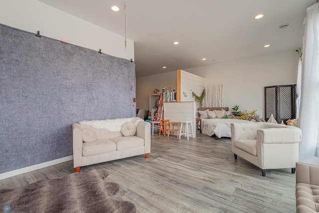 living area featuring recessed lighting, baseboards, and wood finished floors