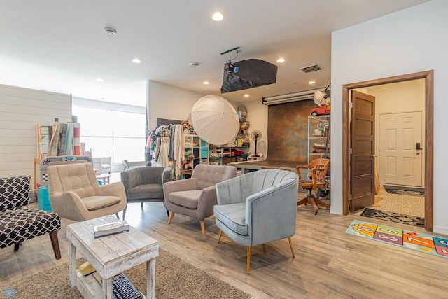 living room featuring recessed lighting, light wood-style floors, and visible vents