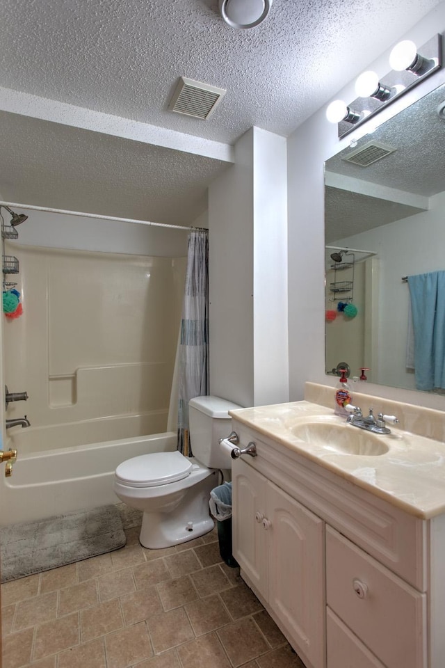 full bath featuring visible vents, toilet, vanity, and a textured ceiling