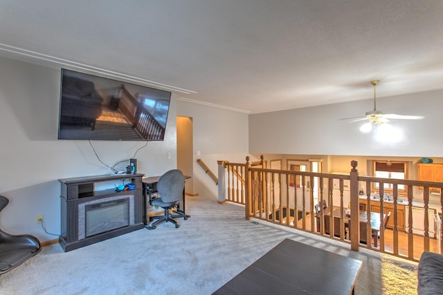 office space with a glass covered fireplace, a ceiling fan, baseboards, and carpet floors