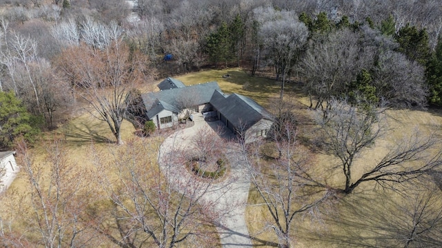 birds eye view of property with a view of trees